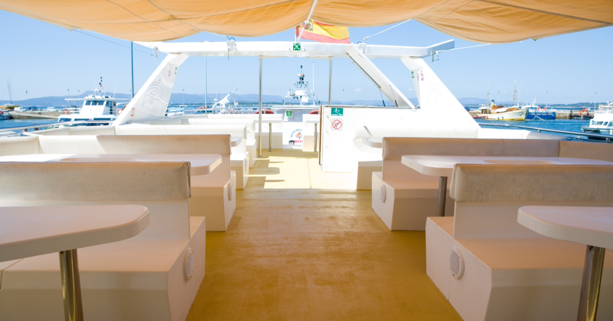 Terraza superior del barco restaurante con toldo, vista abierta al mar
